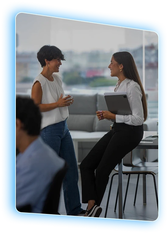 Two colleagues in conversation in an open office