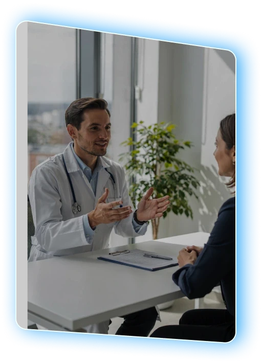 Clinician talking with a patient across a desk